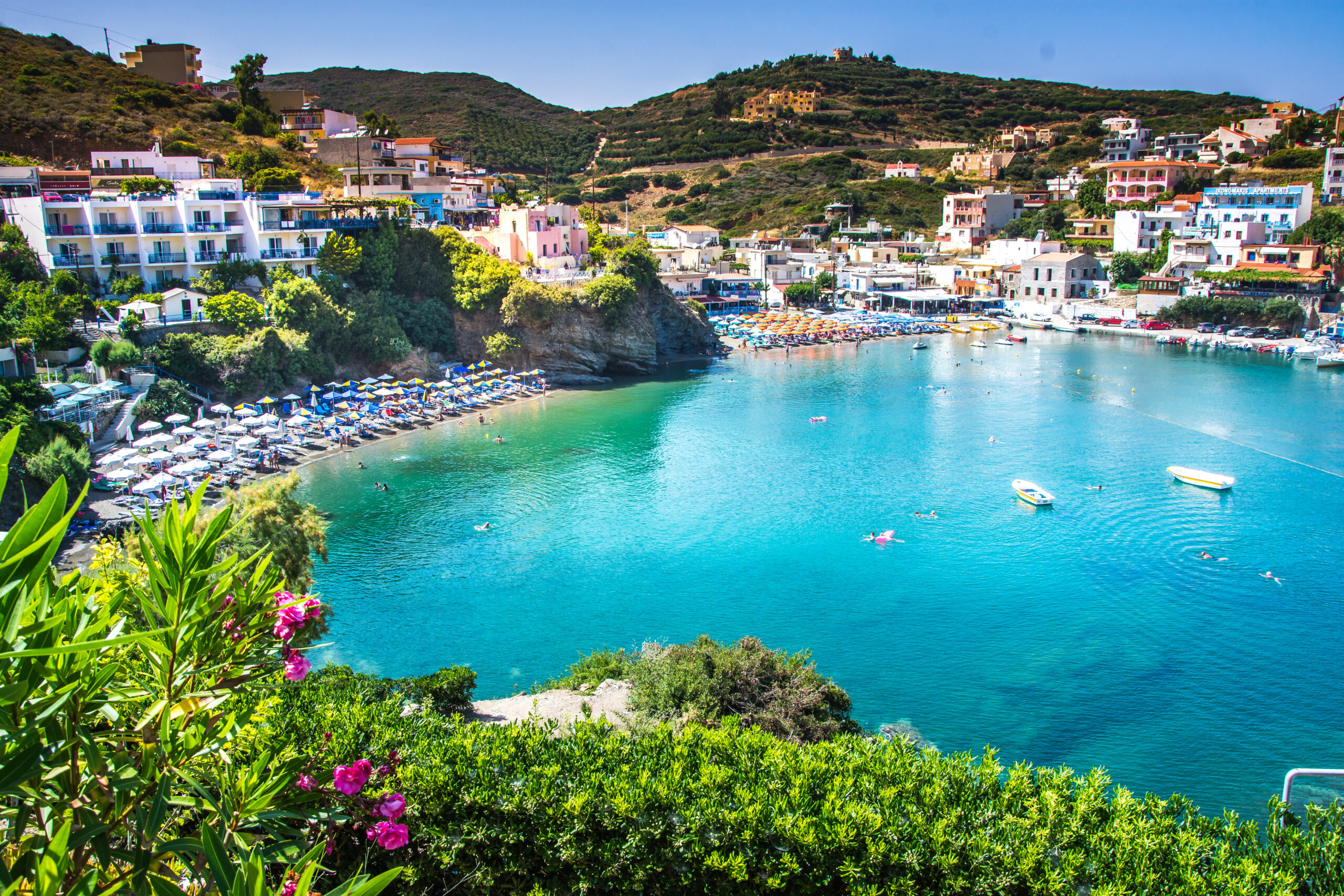 bali, island crete, greece, sunny day scenery scenery with mountains, mediterranean sea, flowers and pier with boats and ship for walking tourists in the sea near village bali