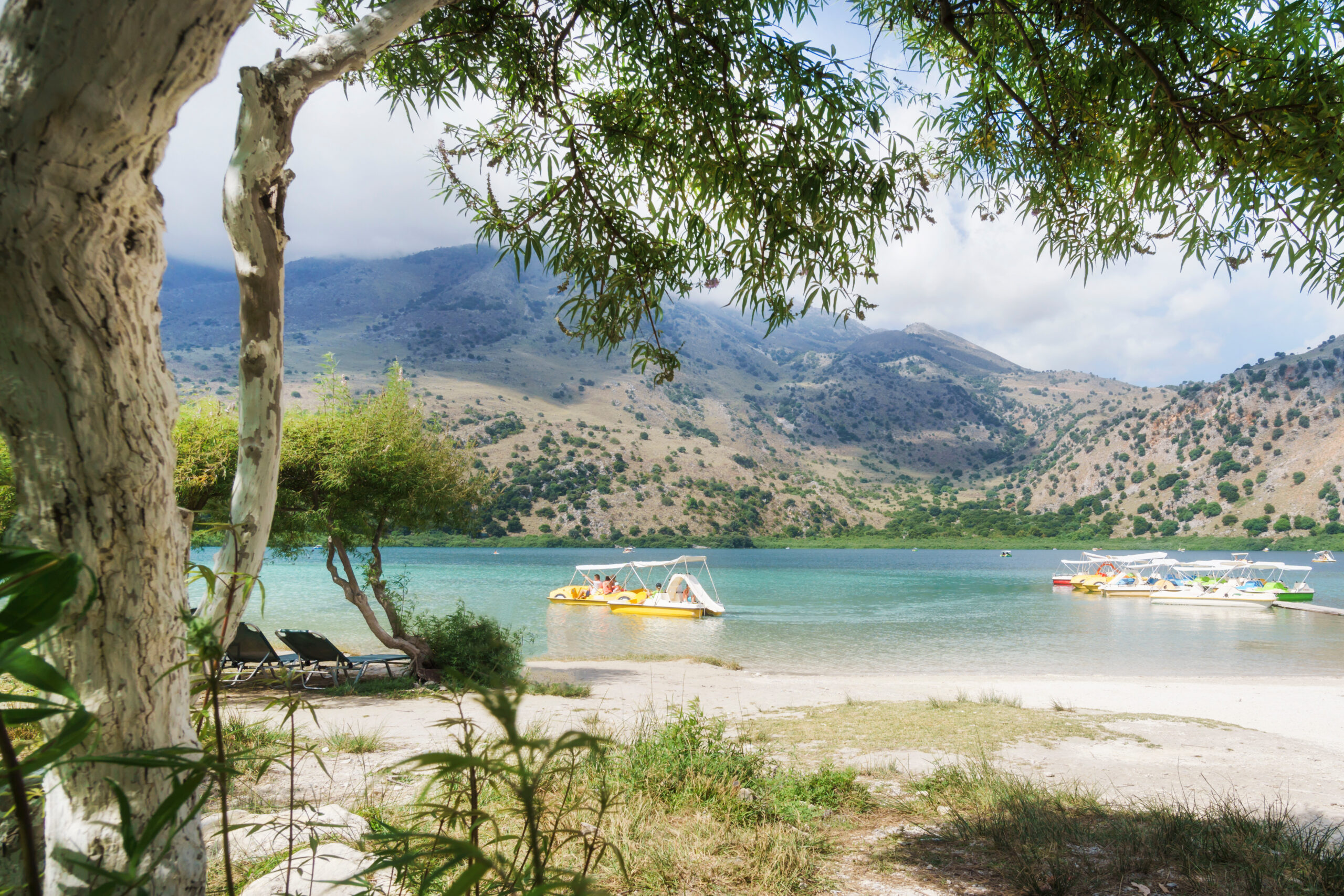 people on the boats on the mountain lake kournas on crete.