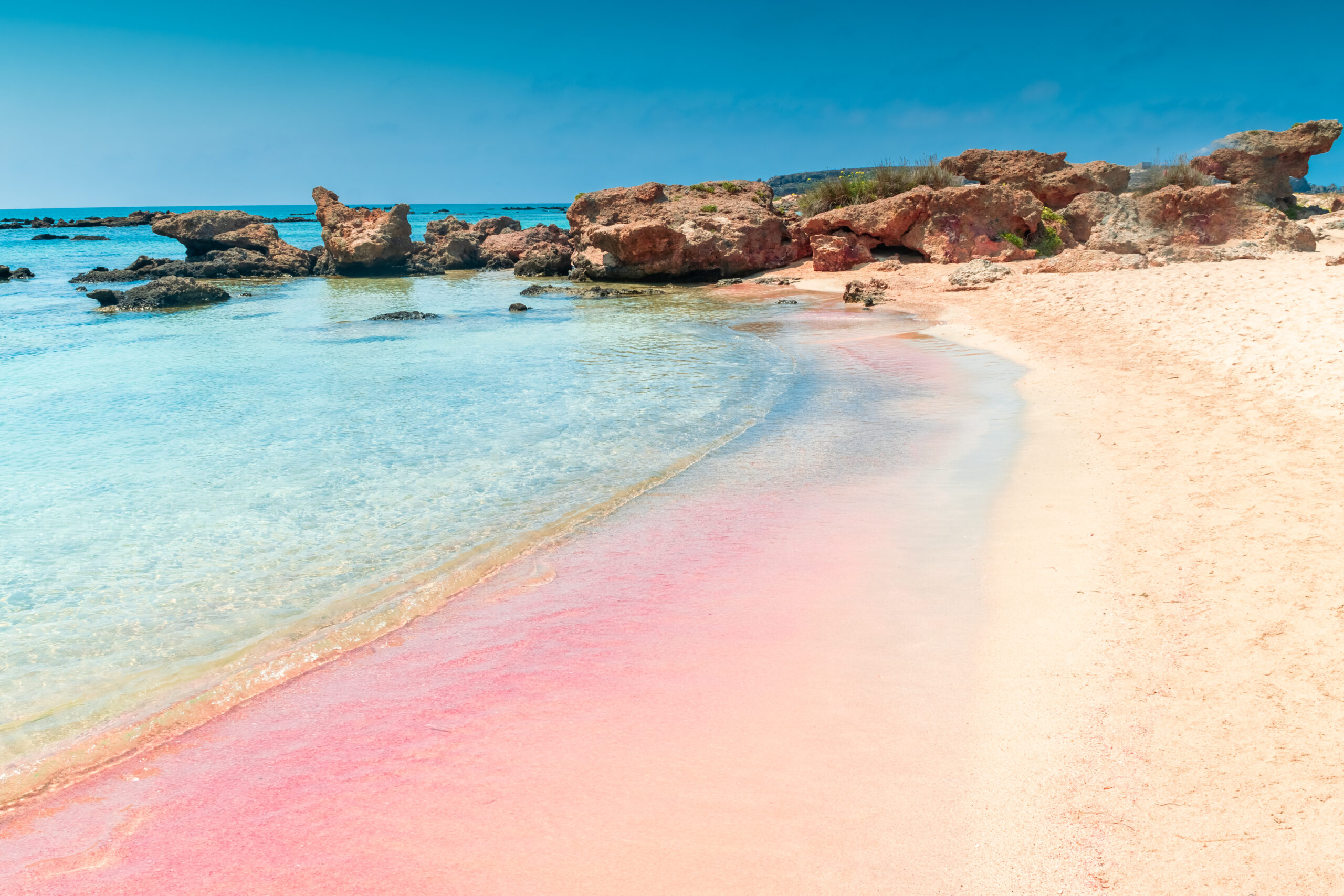 amazing pink sand beach with crystal clear water in elafonissi beach, crete, greece